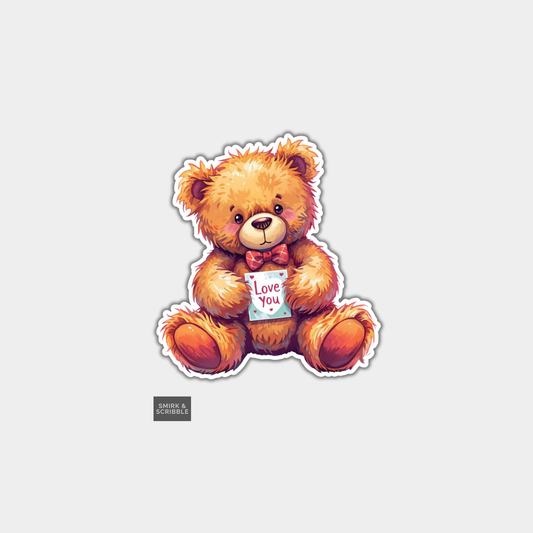 Sticker of a teddy bear holding a 'Love You' card on a light gray background
